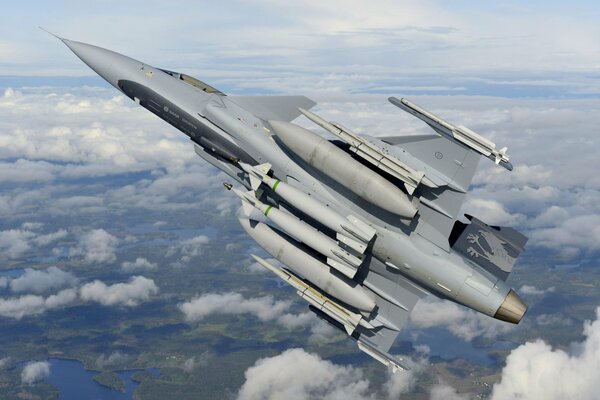 A multi-purpose fighter flying above the clouds