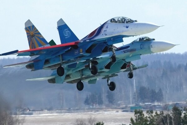 Two Russian fighter jets take off into the air in the forest
