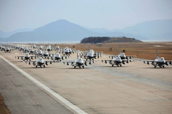 Fighter jets on the runway against the backdrop of mountains