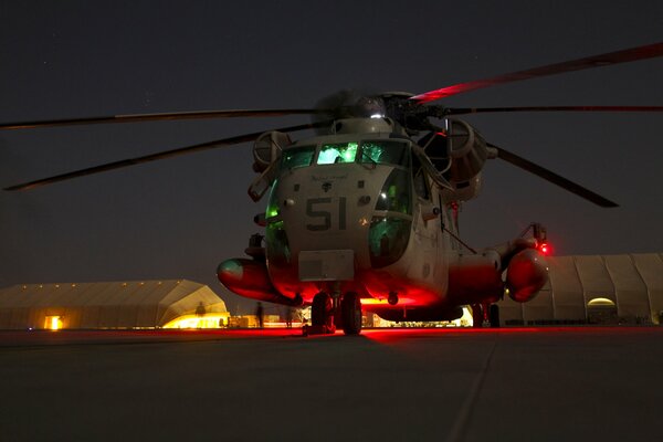 CH-53d stands at night next to the Marine Corps