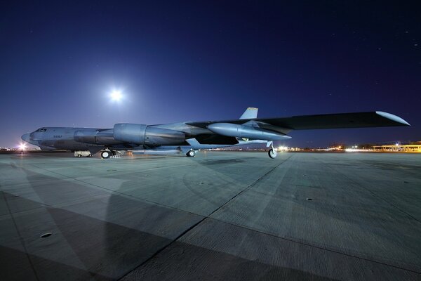 A night airfield and a plane waiting for its passengers