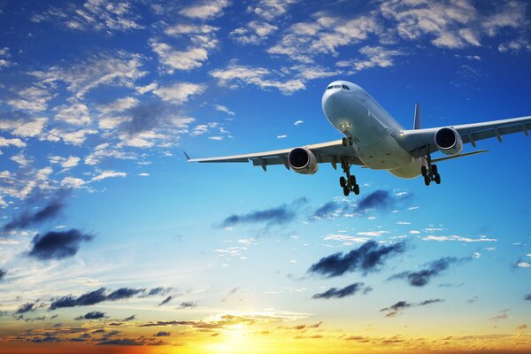 An airliner flying against the background of sunset