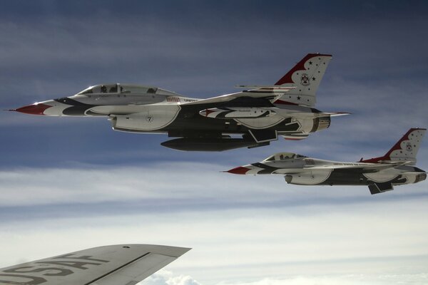 F-16 fighters perform a complex aerial figure