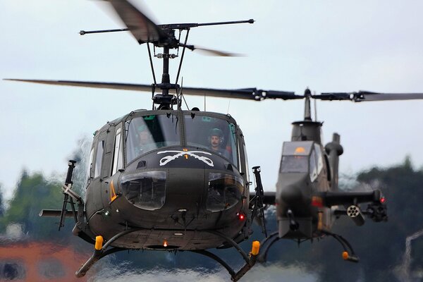 Military helicopters land at the airfield