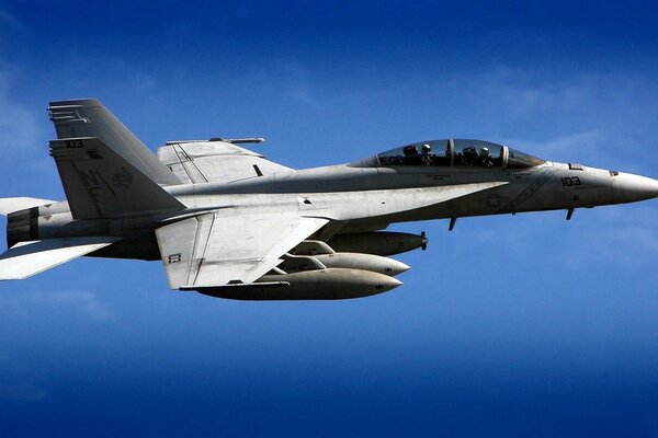 Fighter jet in the sky on a blue background