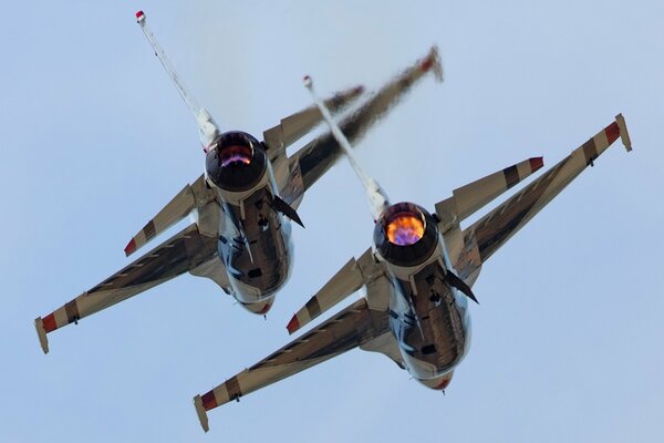 Paired fighter aircraft in the sky