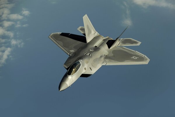 A powerful f-22 fighter jet is flying in the sky