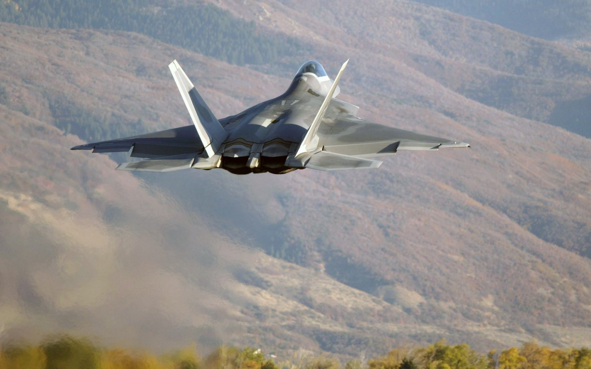 lockheed / boeing f-22 raptor wielozadaniowy myśliwiec piątej generacji lot drzewa góry wzgórza start zdjęcie