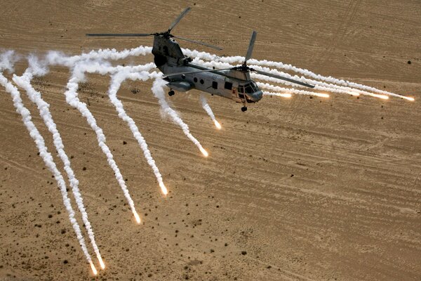 Helicopter fires rockets in the desert