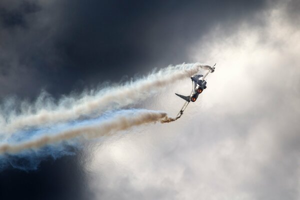 A fighter plane is flying in the clouds