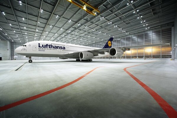 Passenger plane in a lighted hangar