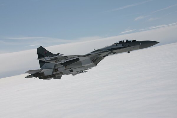 The fighter is flying through a cloudless sky