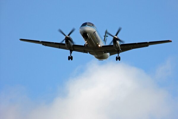 A picture of a saab 2000 plane flying in the sky