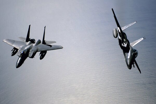 Two fighters over the sea surface