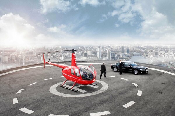 Biznesmen na lądowisku dla helikopterów wsiada do Audi