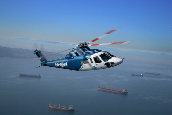 Helijet s-76 helicopter on the background of ships