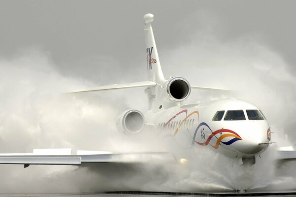 Painting a white plane stands on the runway in smoke