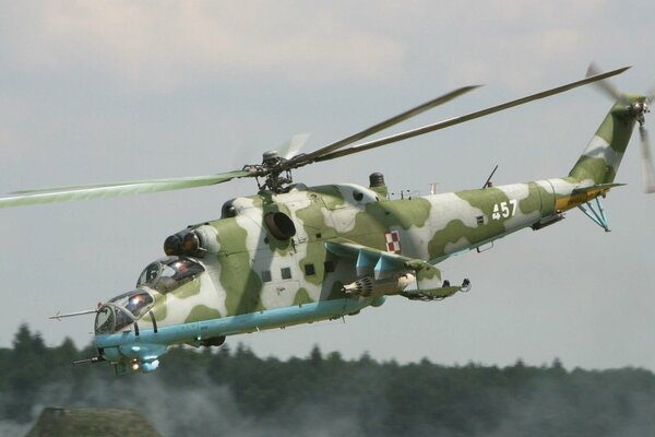 The Soviet transport and combat Mi-24 is not far from the forest area