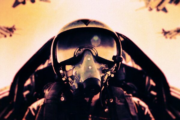 The pilot of a fighter plane in a helmet