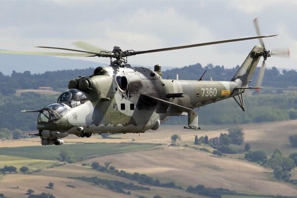 A military helicopter hovering with the ease of a dragonfly