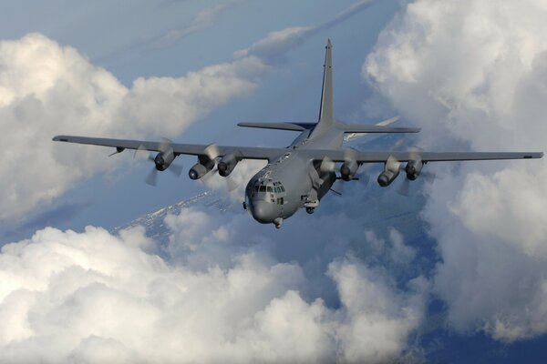 A big plane is flying above the clouds