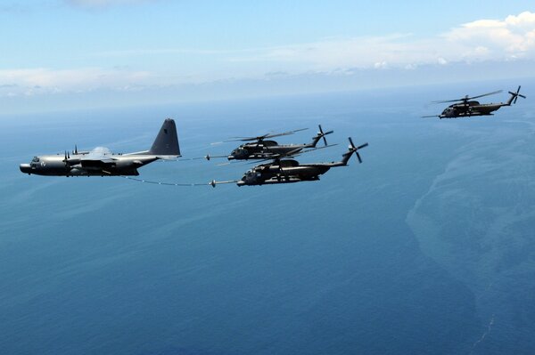 The refueller refuels two helicopters in the air at the same time