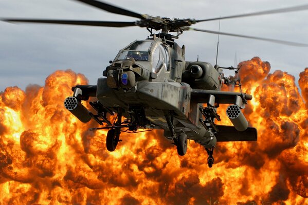Apache helicopter on the background of fire from a powerful explosion