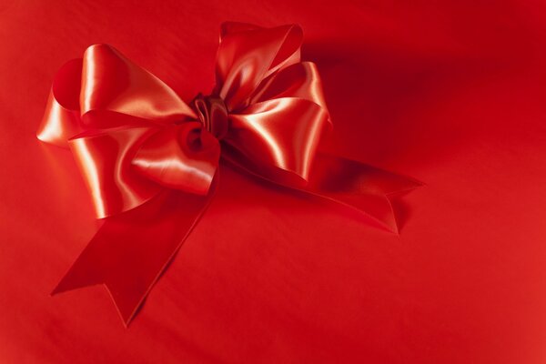 Red bow on a red background