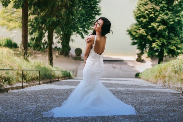 A girl in a beautiful wedding dress with an open back