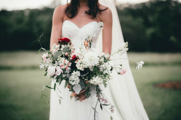 The bride holds a bouquet of flowers