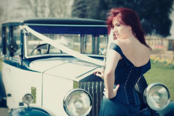 A gorgeous woman at a retro car