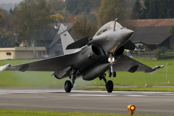 A fighter jet on the runway is about to take off