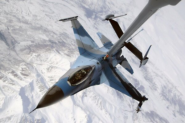 Refueling the aircraft at altitude in the area of the mountain range