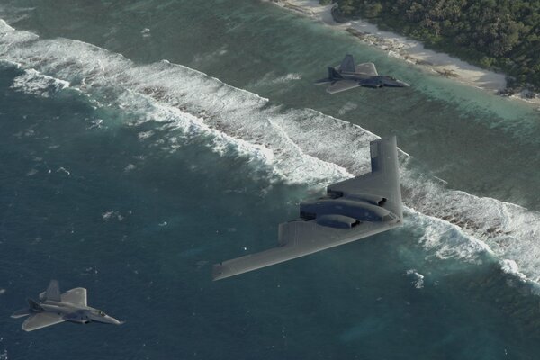 Two f22s fly over the Pacific Ocean