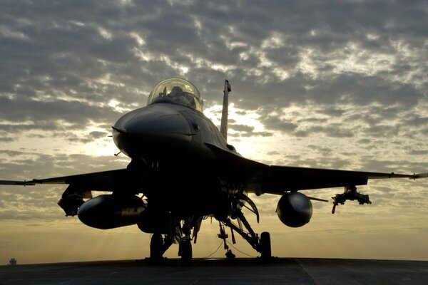 Fighter on an aircraft carrier, sunset