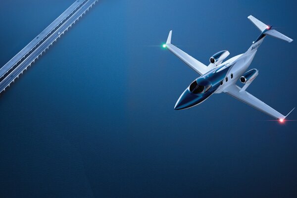 Photo of an airplane on the background of a bridge over a river