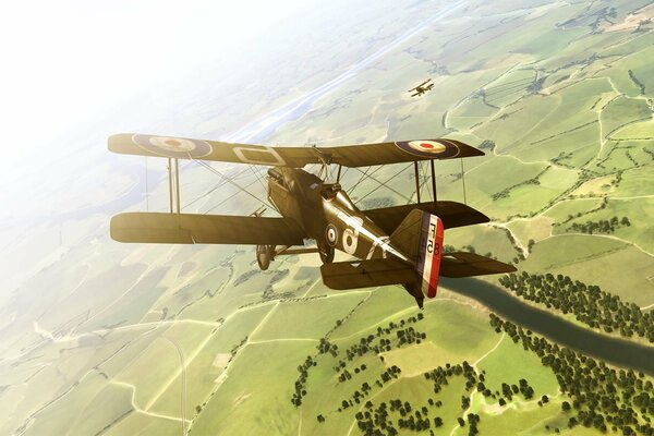 A plane with double wings flies over the fields