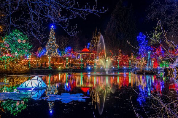 The park in lights in the reflection of the pond