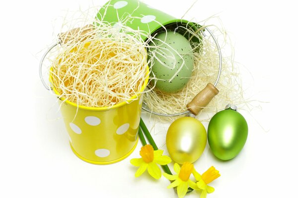 Two bright buckets, painted Easter eggs and daffodils