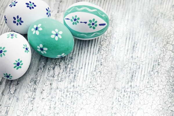 Painted blue-white-green eggs on the table