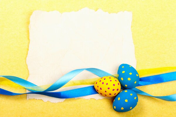 A blue ribbon next to the painted eggs