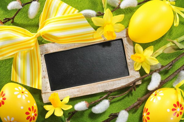 Yellow flowered eggs on a green background with flowers, willow, yellow bow and signature frame