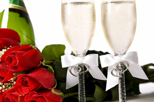 Bouquet of red roses and sparkling wine in bakals