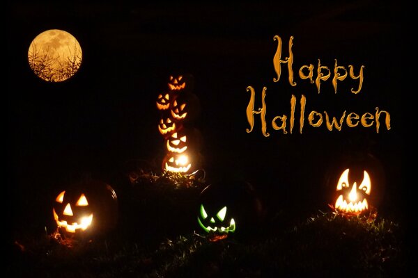 Pumpkins with glowing faces under the night moon with the inscription Happy Halloween 