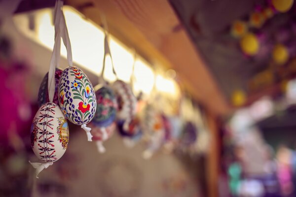 Easter decorated eggs hanging on ropes