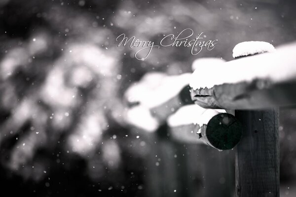 The inscription merry Christmas on the background of snow