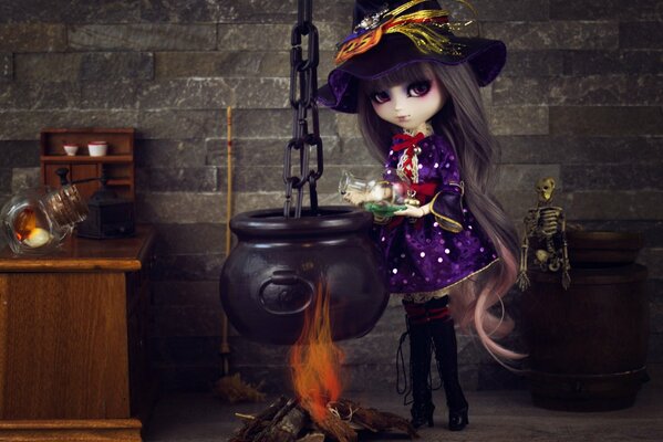 A doll in a witch costume over a witch s cauldron