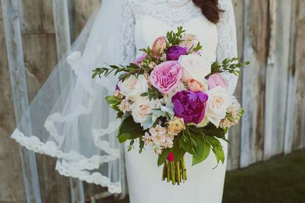 Bride with a bouquet of peonies