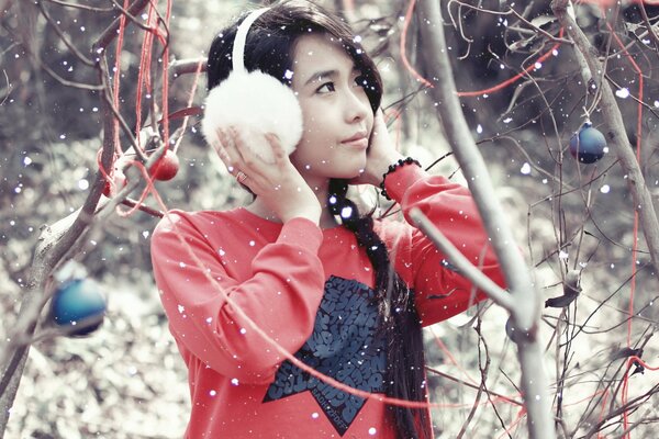 Winter garden fairy tale with an Asian girl
