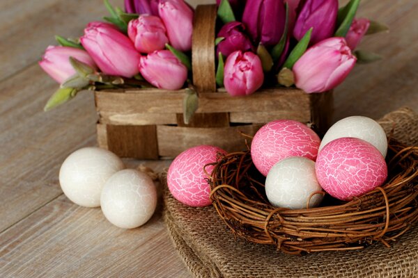 Easter basket with eggs and a basket with tulips